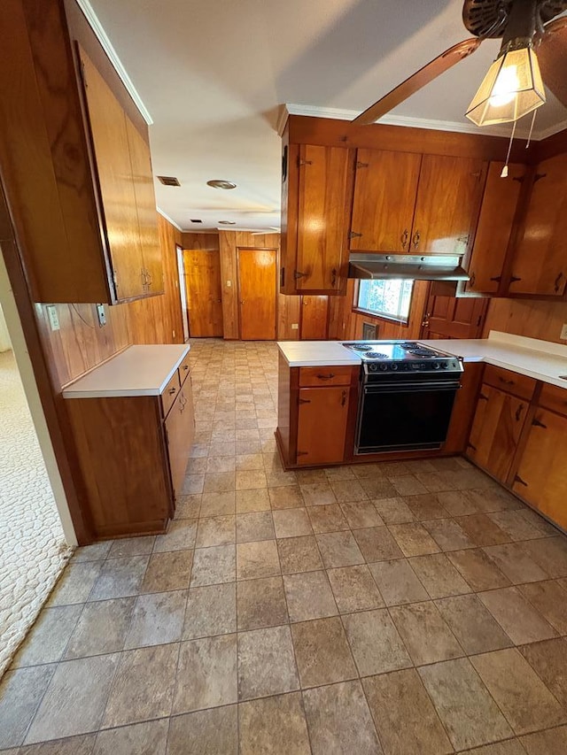 kitchen with range with electric cooktop, under cabinet range hood, wood walls, light countertops, and brown cabinets