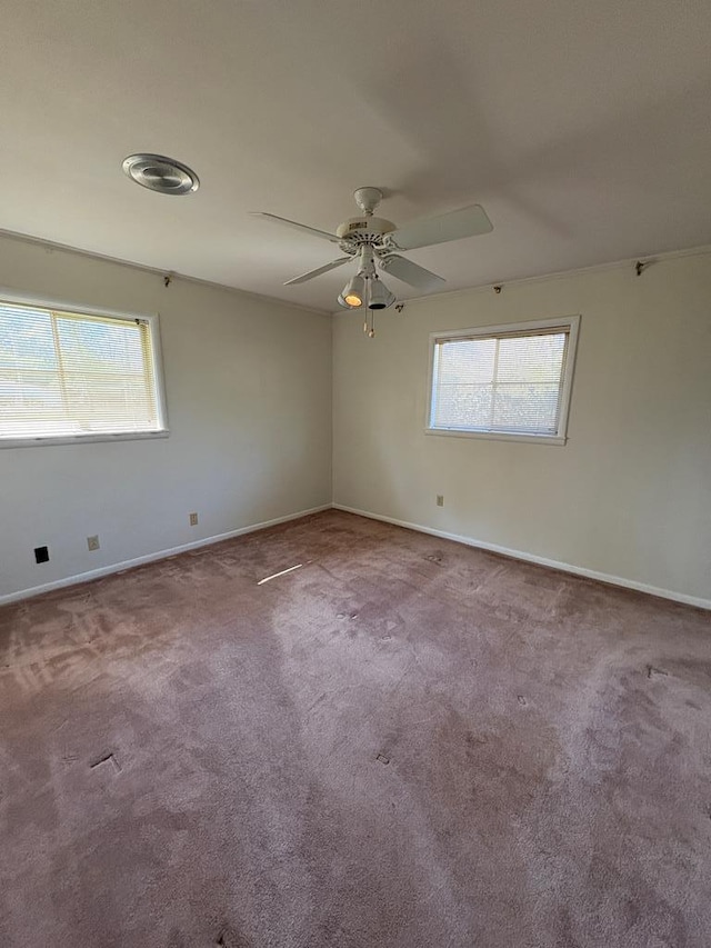 spare room featuring baseboards, a ceiling fan, and carpet flooring