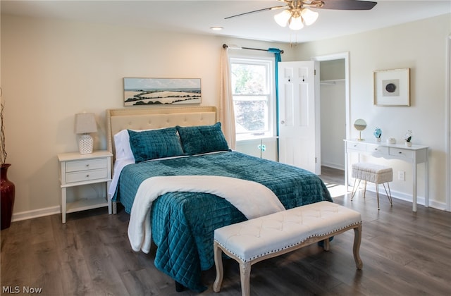 bedroom featuring dark wood-type flooring, a closet, and ceiling fan