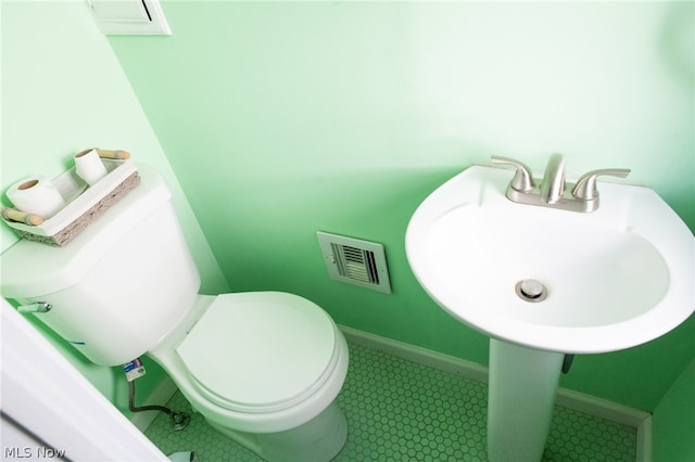 bathroom featuring tile floors and toilet