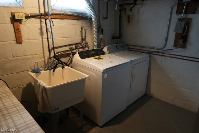 clothes washing area featuring independent washer and dryer and sink