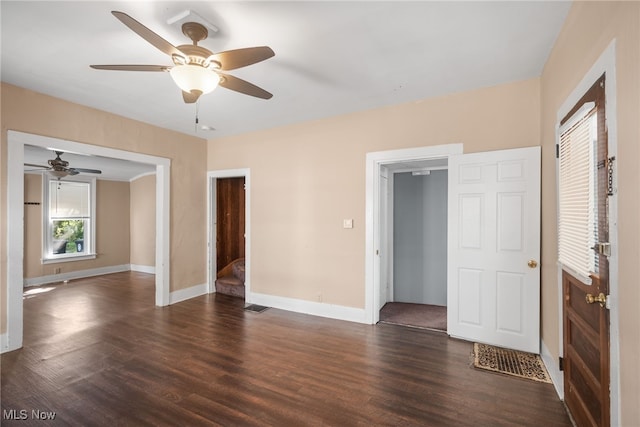 unfurnished bedroom featuring ceiling fan and dark hardwood / wood-style flooring