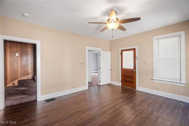 interior space with ceiling fan, a closet, and dark hardwood / wood-style flooring