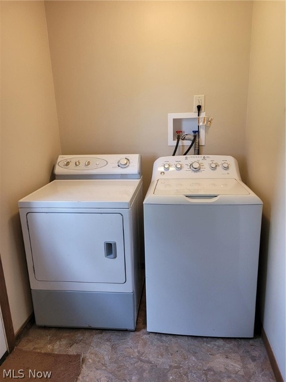 laundry area with light tile patterned floors and separate washer and dryer