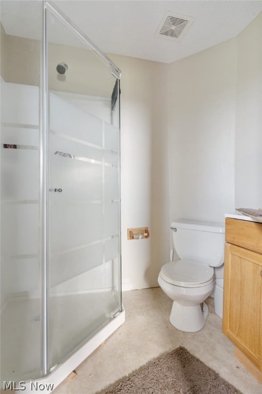 bathroom with vanity, toilet, concrete flooring, and an enclosed shower