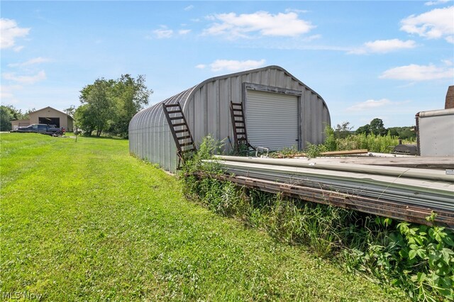 view of outdoor structure with a garage and a yard