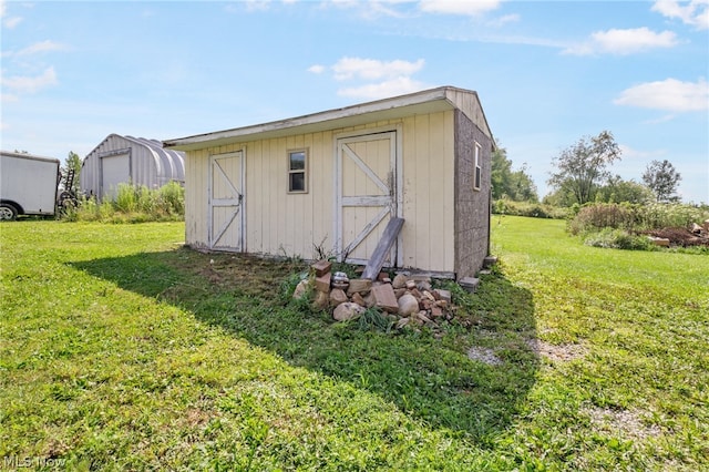 view of outbuilding with a yard