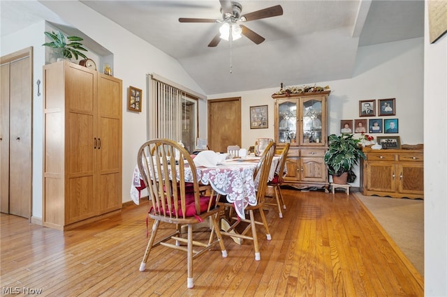 dining room with lofted ceiling, light hardwood / wood-style flooring, and ceiling fan