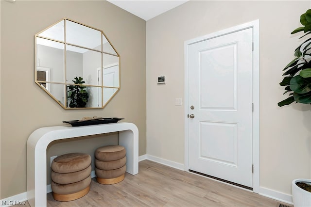 foyer entrance with light hardwood / wood-style floors