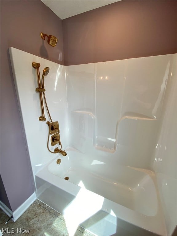 bathroom with shower / washtub combination