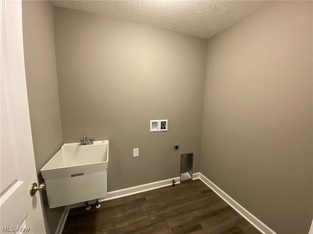 clothes washing area featuring washer hookup, hookup for an electric dryer, a textured ceiling, and dark hardwood / wood-style floors