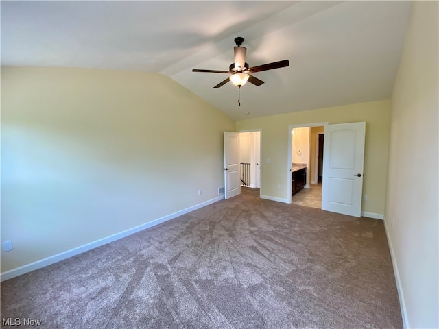 unfurnished bedroom with carpet floors, connected bathroom, vaulted ceiling, ceiling fan, and baseboards