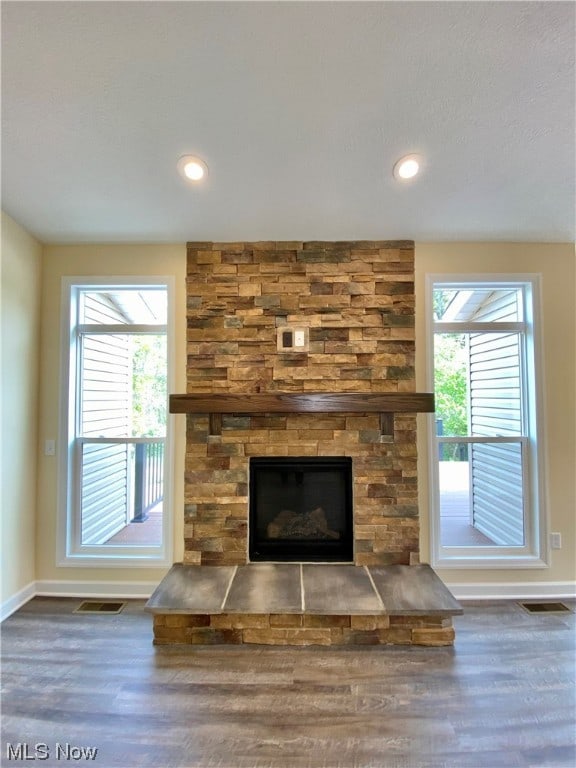 unfurnished living room with a fireplace and dark hardwood / wood-style flooring