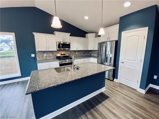 kitchen featuring light wood-style floors, tasteful backsplash, appliances with stainless steel finishes, and white cabinets