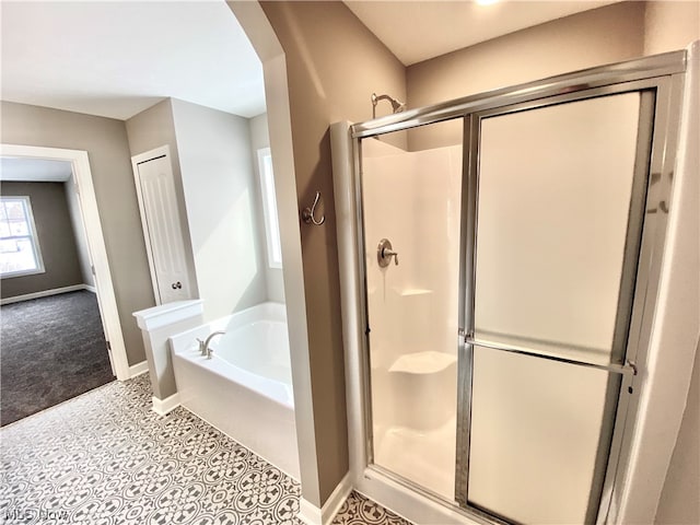 full bathroom featuring a garden tub, tile patterned flooring, baseboards, and a stall shower