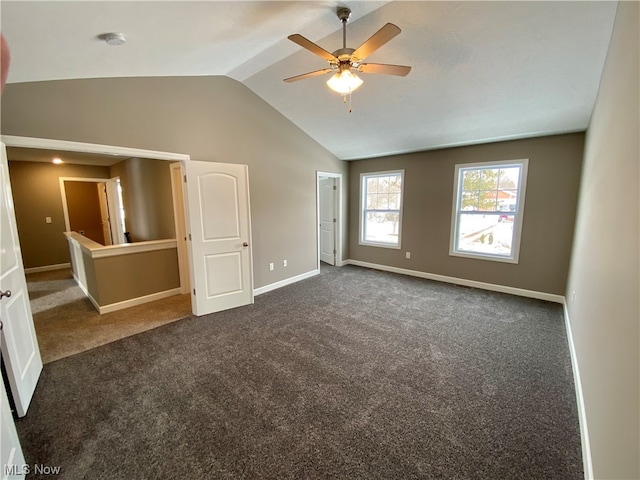 unfurnished bedroom with lofted ceiling, baseboards, ceiling fan, and dark colored carpet