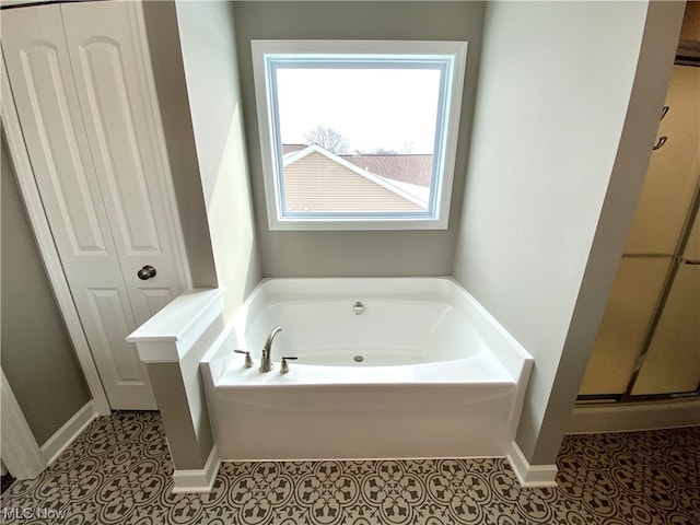 bathroom featuring shower with separate bathtub and tile patterned floors