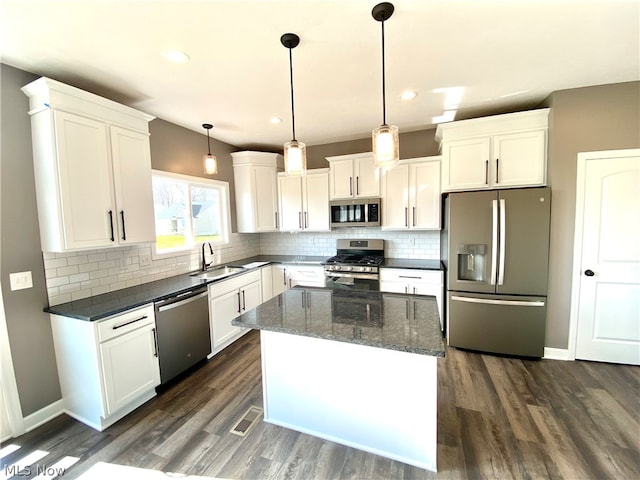 kitchen with stainless steel appliances, visible vents, a sink, and white cabinetry