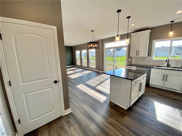 kitchen featuring white cabinets, plenty of natural light, sink, and a chandelier