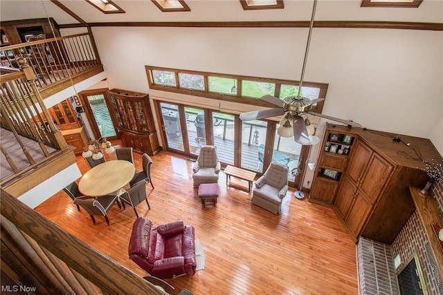 347 State Route 14, Columbiana, OH 44408 - living room with light wood-type flooring, ceiling fan, ornamental molding, and a towering ceiling