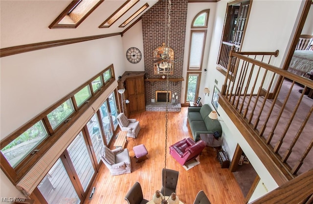 347 State Route 14, Columbiana, OH 44408 - living room featuring high vaulted ceiling, wood-type flooring, ornamental molding, and a fireplace