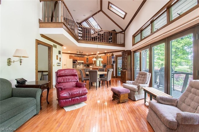 347 State Route 14, Columbiana, OH 44408 - living room with light hardwood / wood-style flooring, a skylight, a notable chandelier, and a towering ceiling