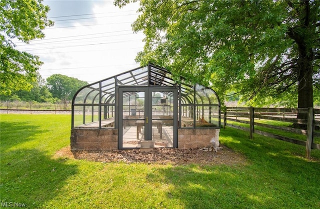 surrounding community featuring an outbuilding and a yard