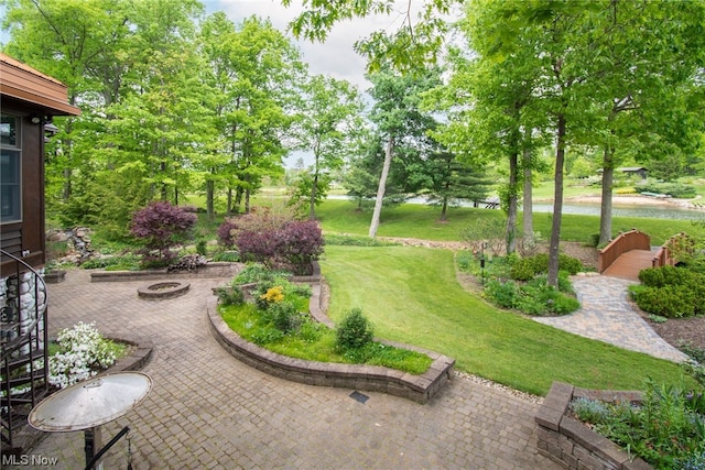 view of yard featuring a fire pit and a patio area