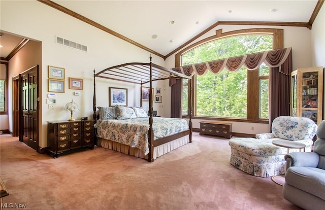 carpeted bedroom featuring high vaulted ceiling and crown molding