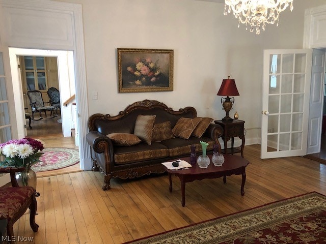 living room featuring hardwood / wood-style floors and a chandelier