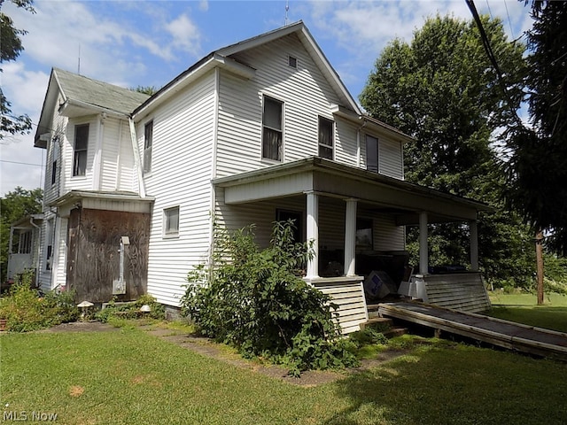 view of front of home with a front yard and a porch