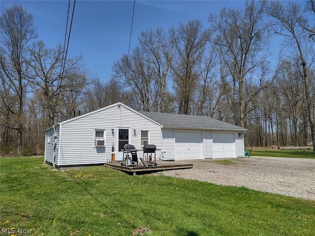 view of front of house with a wooden deck, a front yard, and a garage