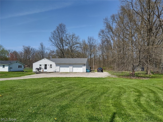 exterior space featuring a garage, a front yard, and an outdoor structure