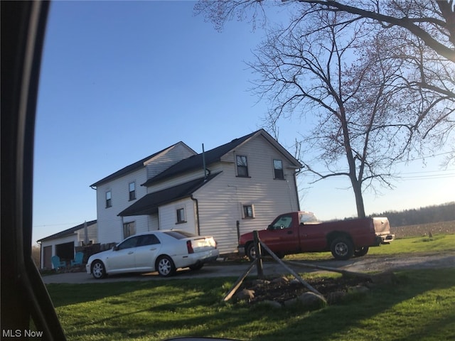 rear view of property featuring a yard