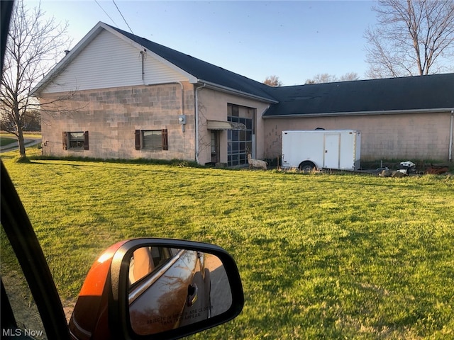 rear view of house featuring a yard