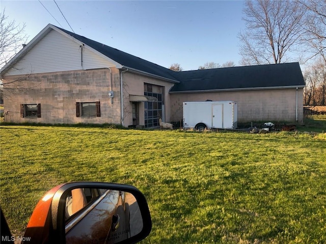 view of property exterior with a yard