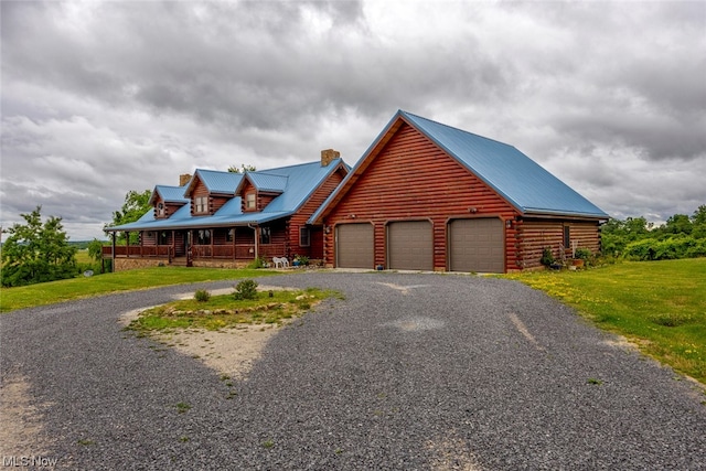 log home with a garage, a front yard, and a porch