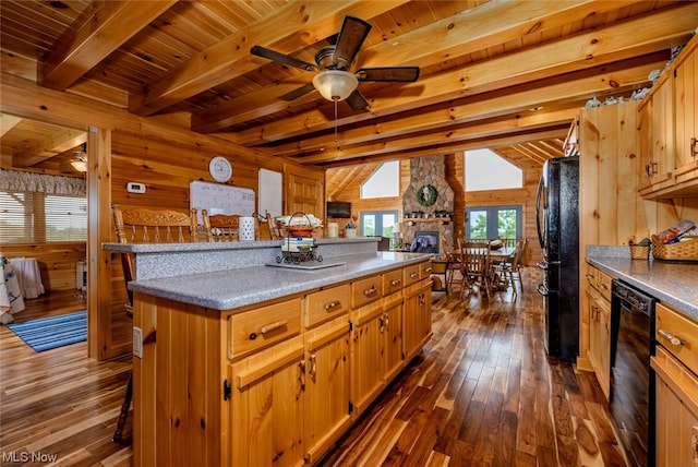 kitchen featuring a fireplace, a kitchen breakfast bar, ceiling fan, and black appliances