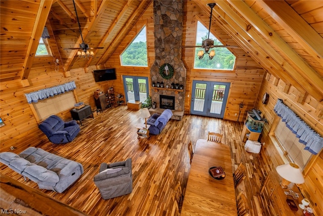 living room with ceiling fan, wood ceiling, and plenty of natural light