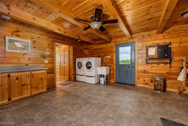 laundry area with washer and clothes dryer, wood walls, sink, ceiling fan, and wooden ceiling