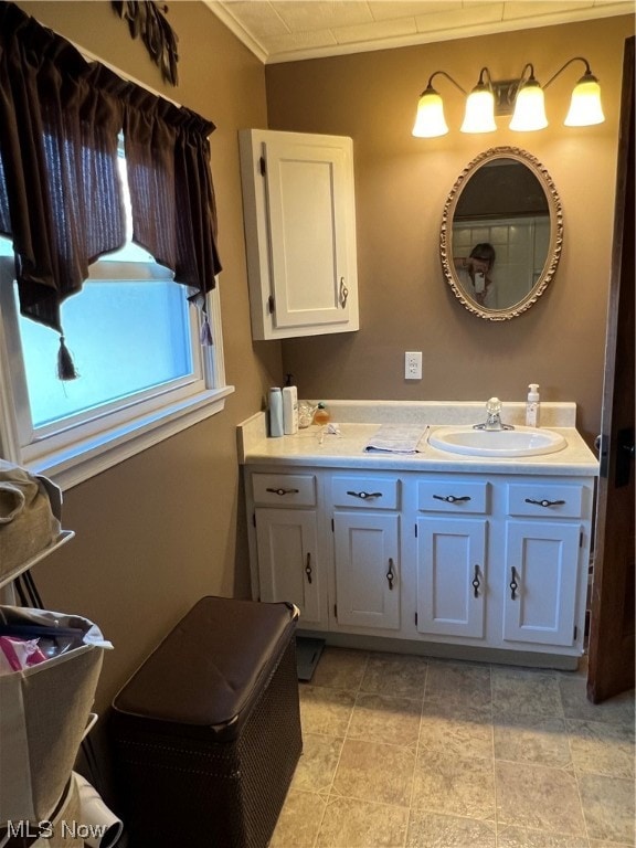 bathroom with tile flooring, double sink vanity, and ornamental molding