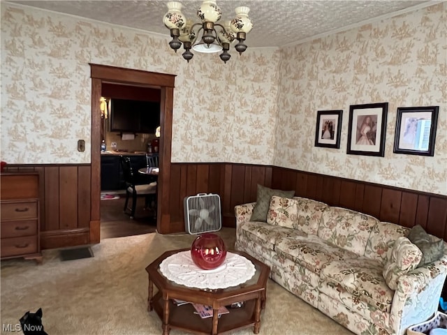 carpeted living room with an inviting chandelier and a textured ceiling