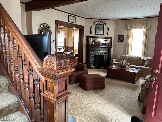 911 Grandview Ave, New Matamoras, OH 45767 - carpeted living room with a tiled fireplace, ornamental molding, stairs, and a textured ceiling