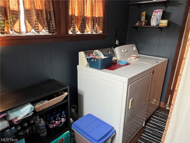 clothes washing area featuring washer and dryer and hardwood / wood-style floors