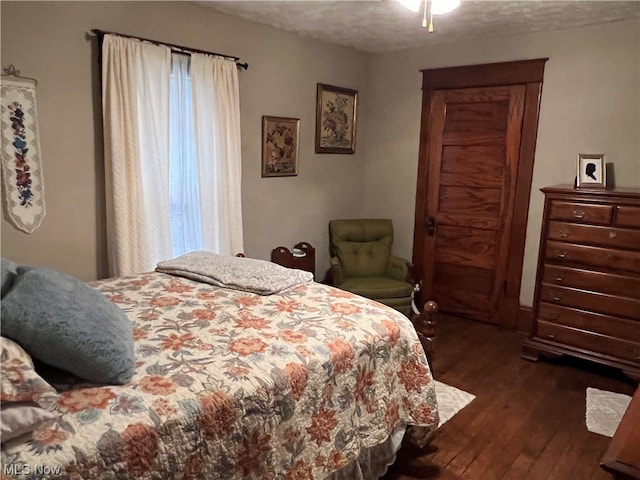 bedroom with dark hardwood / wood-style floors