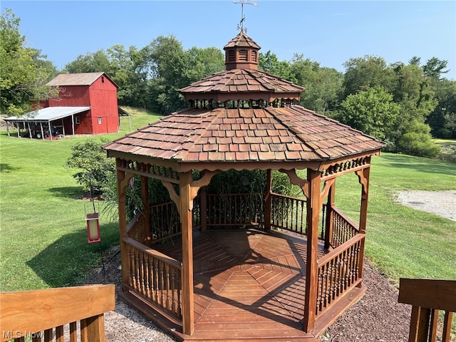 wooden terrace with a yard and a gazebo