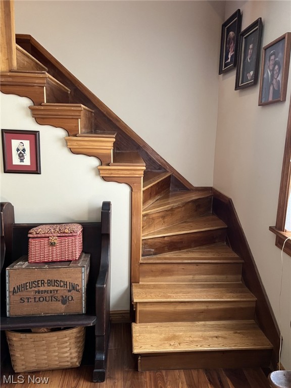 staircase featuring dark hardwood / wood-style flooring