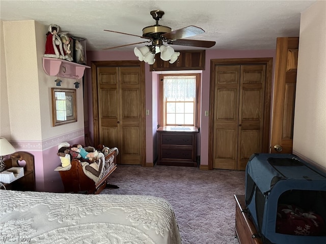 carpeted bedroom with a textured ceiling and ceiling fan