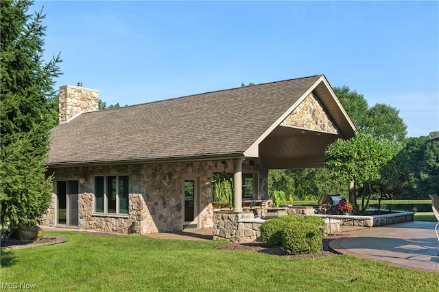 view of home's community featuring a lawn and a patio