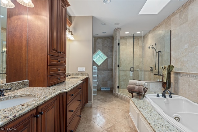 bathroom with a skylight, tile patterned flooring, shower with separate bathtub, ceiling fan, and vanity